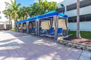 a group of blue chairs under a gazebo at Ocean View 15th floor Apartment Sunny Isles in Sunny Isles Beach