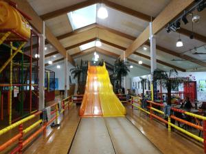 an indoor playground with a yellow slide in a room at Top Appartment mit Weitblick und Late Check-Out inklusive aktivCARD in Sankt Englmar