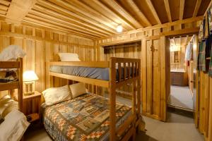 にあるQuaint Regis Retreat on Black Diamond Ranch!の木造キャビン内のベッドルーム1室(二段ベッド2組付)