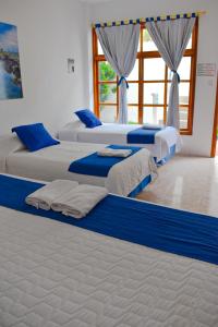 Voodi või voodid majutusasutuse Gran Hostal Tintorera toas