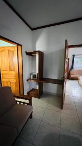 a living room with a couch and a door at Villa Anse Possession in Baie Sainte Anne