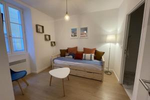 a bedroom with a bed and a table and a chair at Nice and modern flat at the heart of Panier in Marseille - Welkeys in Marseille