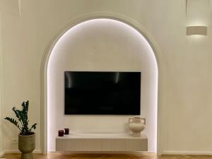 an arched niche with a tv in a living room at Arch IV. in Prague