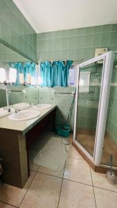 a bathroom with a shower and a sink and a mirror at Villa Anse Possession in Baie Sainte Anne