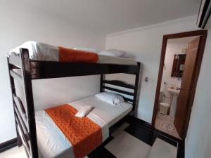 two bunk beds in a room with a mirror at Apartamento Villa llano in Villavicencio