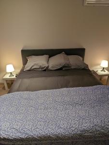 a bed in a bedroom with two lamps on tables at Holiday Nice Studio in Nice