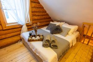 a bedroom with a bed with shoes on it at Jaunlidumnieki in Mālpils