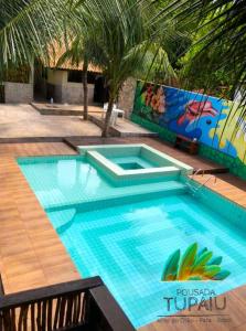 a large swimming pool with a large blue swimming poolvisor at Pousada Tupaiú in Alter do Chao