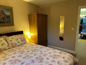 a bedroom with a bed and a dresser at Beechcroft Corner House in Ecclesall