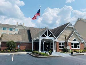 an american flag flying in front of a building at ReVi Columbus North in Columbus