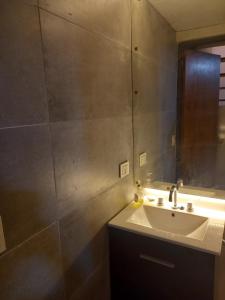 a bathroom with a sink and a mirror at Cabañas LUNALUMA in Barrancas