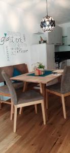 a wooden table with chairs and a dining room at Residence Maximilian in Vipiteno