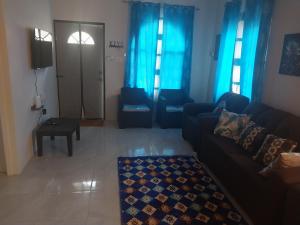 a living room with blue curtains and a couch at Debs Cozy Cove in Discovery Bay