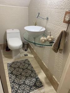 a bathroom with a sink and a toilet at Itacimirim Villas da Praia in Camacari