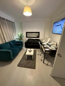 a living room with a couch and a table at 3 Bedroom King Cross station City centre London in London