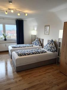 2 camas en una habitación grande con ventana en Ferienwohnung Allgäu 5 en Memmingen