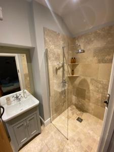 a bathroom with a shower and a sink at The Annexe in Middleham