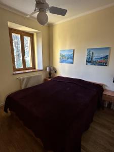 a bedroom with a bed and a ceiling fan at Apartment BelLenno in Lenno