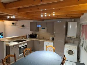 a kitchen with a table and a kitchen with a washer at La Boussole in Étretat