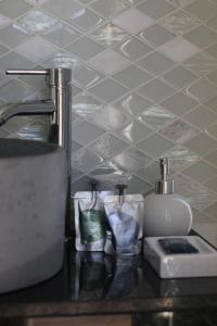 a kitchen counter with a sink and a counter top with towels at Zambujal Suites in Sesimbra