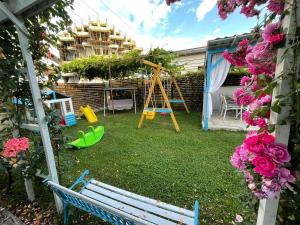 a yard with a swing and a playground at Vila Viorica in Mamaia Sat/Năvodari