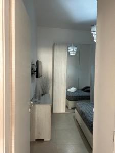 a bedroom with two beds and a desk and a mirror at La Cupola - casa vacanze n 8 in Termini Imerese
