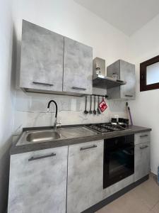 a kitchen with stainless steel cabinets and a sink at La Cupola - casa vacanze in Termini Imerese