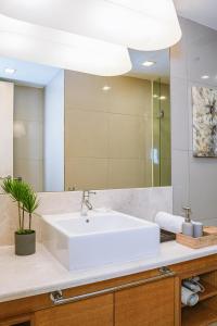 a bathroom with a white sink and a mirror at 7 PAX, 1BR, 3mins to KLCC (3A05) in Kuala Lumpur