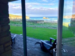 a view of the ocean from the porch of a house at Chapel Rock View, The Dunes in Perranporth