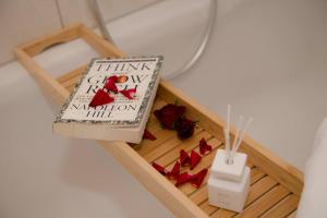 a small wooden box with a book and red heels at Entire Tulum Apartment, in the Center of Vienna in Vienna