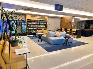 a lobby with a couch and tables in a store at STAY Blend SmartStyle in Goiânia
