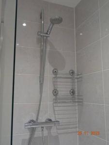 a shower in a bathroom with a glass door at Magnolia Palace/Group Long Stays in Killingbeck