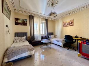 a bedroom with two beds and a couch and a table at Panoramic view of downtown Rabat in Rabat