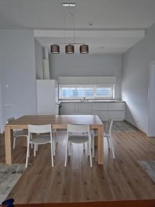 a kitchen and dining room with a table and chairs at IG House in Druskininkai