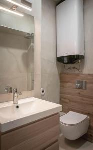 a bathroom with a white sink and a toilet at Central Apartment in Varna in Varna City