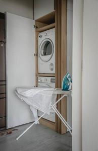 a kitchen with a microwave and a washer and dryer at Central Apartment in Varna in Varna City
