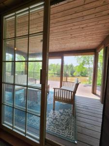 a porch with a bench and a swimming pool at Riverfront~On ATV Trials~Near Mackinac Island in Hessel