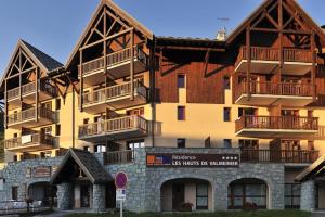 a large building with balconies on top of it at Le ValmySki in Valmeinier