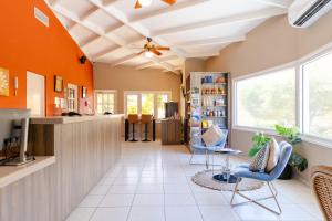 a living room with orange walls and a ceiling at The Royal Sea Aquarium Resort in Willemstad