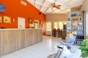 a lobby with an orange wall at The Royal Sea Aquarium Resort in Willemstad