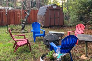 a group of chairs around a fire pit in a yard at Magical Redwood Getaway-Outdoor Tub & Dog-Friendly in Fort Bragg