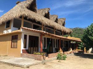 un edificio con techo de paja en Hab #11 La Casa del Profe Salo, en Zapote