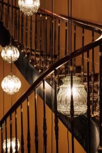 a group of chandeliers hanging from a staircase at Domaine de Locguénolé & Spa - Relais & Chateaux in Kervignac