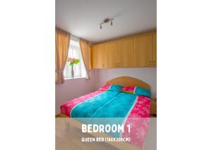 a bedroom with a bed with a colorful blanket at Pardubsky Apartments in Ljubljana