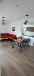 a room with a table and chairs and a couch at Colores De La Quebrada in Cafayate