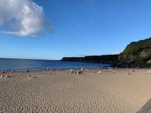 a group of people on a beach near the water at Casa Da Praia in Porto Formoso
