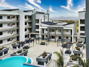 a view of a building with a swimming pool at Nivica 56 Luxury Apartment Langebaan in Langebaan