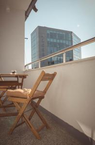 a table and chairs on a balcony with a building at Central Apartment in Varna in Varna City
