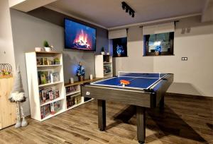 a living room with a pool table and a tv at Zakopiański Zakątek in Zakopane