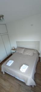 a white bed with two towels on top of it at Colores De La Quebrada in Cafayate